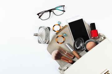 Fashion concept : Flat lay of white  leather woman bag open out with sunglasses and smartphone on white background.- Image