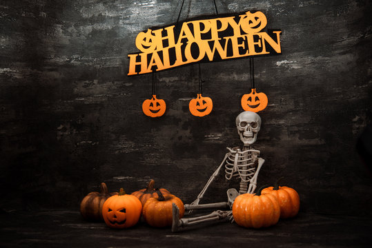 Halloween concept with a pumpkin and skeleton on background