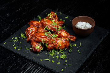 Chicken Wings with tomato barbecue sauce. Sprinkled with dill, onions and parsley.