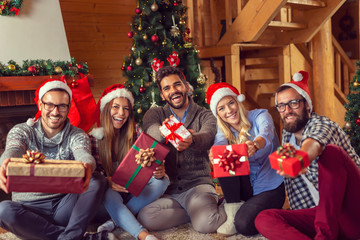 Friends exchanging presents on Christmas morning