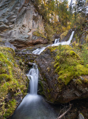 mountain river and waterfall on a background of autumn trees