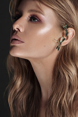 Beautiful young woman with kaffa in the ear. Make up and Jewelry concept - Image