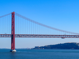 Fototapeta na wymiar 25th April Bridge in Lisbon, Portugal. Famous landmark on river Tagus.