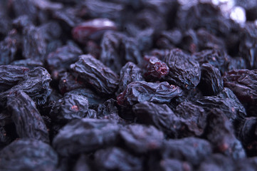 Macro photo of tasty organic black raisins.