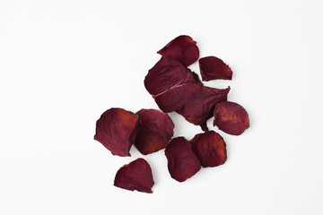 Dry petals of a dark rose on a white background