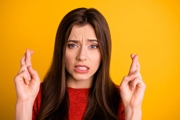 Close up photo of worried panic girlfriend about to cry with fingers crossed with her teeth...