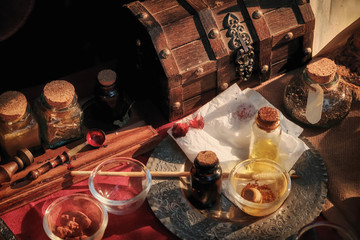 Bottles, chest, spoons and brushes for dye. Items to create paint artists handmade. Creating of paints from mineral components, retro.