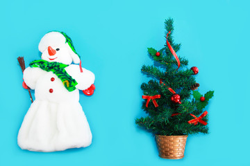 snowman in a white fur coat and Christmas green tree with New Year's decor