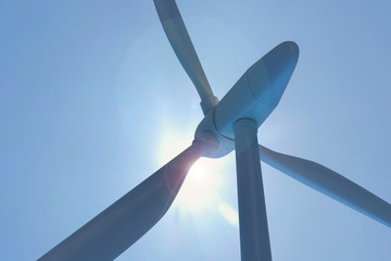 Wind farm against the daylight and blue clear sky. Pure wind energy.