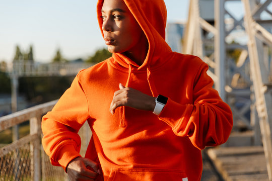 Photo of african american confident woman running while working out