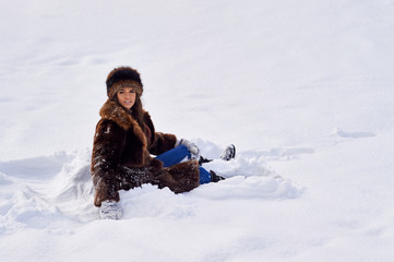 Fototapeta na wymiar Young girl enjoying snow outdoors in winter.
