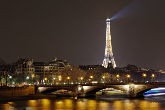 Eiffel Tower with night illumination and Pont des Invalides