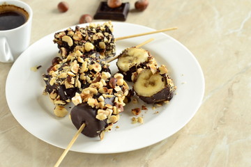 Frozen banana in chocolate and hazelnuts, copy space