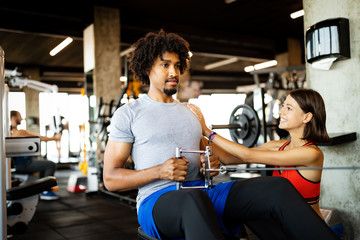 Teamwork in gym. Couple working exercise together.