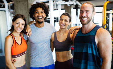 Group of young people doing exercises in gym