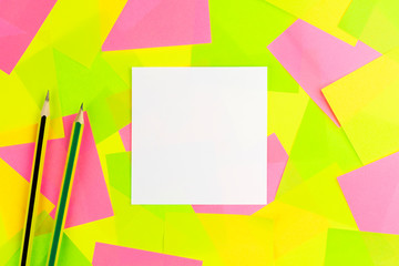 The white paper note ,Yellow pencil with black stripe and Green pencil with yellow stripe put on colorful sticky note background..