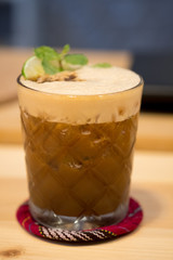 Espresso, mint and lime cocktail in a glass.