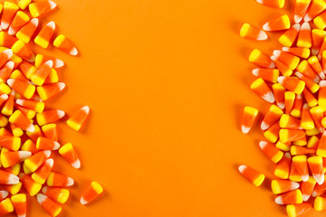 Bunch of candy corn sweets as sybol of Halloween hoiday on textured background with a lot of copy...