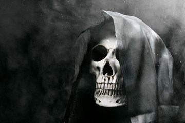 Human skull with a black cloak