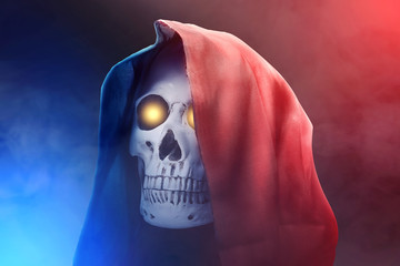 Human skull with a black cloak