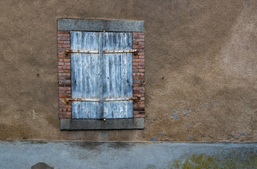Close up on Closed old  weathered  window shutters in rural France