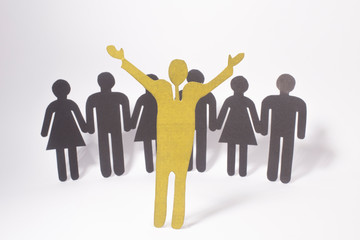 Group of paper people holding hands.