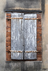 Close up on Closed old  weathered  window shutters in rural France