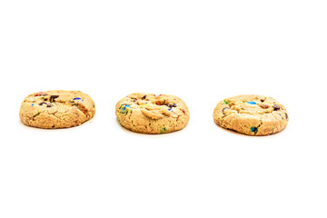 Cookies with colored chocolate dragees on a white background.