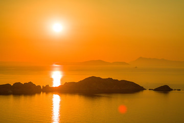 Obraz premium Beautiful sunset with rocks silhouette on Porto Timony - Corfu, Greece, Europe