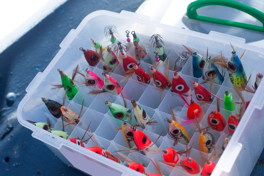 Colorful fishing lures in an old tackle box.