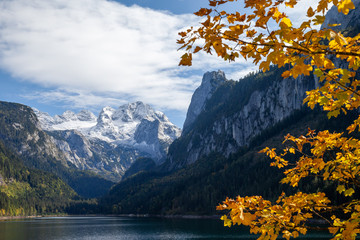 Mount Dachstein seen from famous Lake Gosau, Austria. A colorfull autumn spectacle is ongoing in...