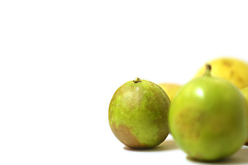 fresh and green lemon with tainted lemon on a white background
