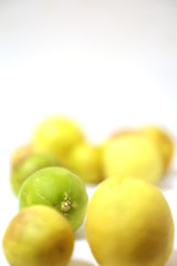fresh and green lemon with tainted lemon on a white background