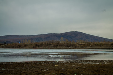 View of the Silinka River flowing into the Amur River. Spring in Russia.