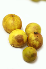 fresh and green lemon with tainted lemon on a white background, top view