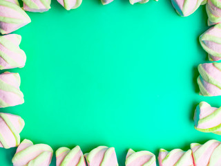 Lots of little marshmallows on trendy mint background