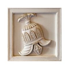 White marble element of the interior with the image of the helmet from the ancient Greek myth. The element is isolated on white background
