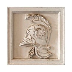 White marble element of the interior with the image of the helmet from the ancient Greek myth. The element is isolated on white background