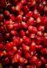 Punica granatum grains on a plate. Background of berries.