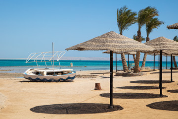 Straw sunshade umbrellas on the beach