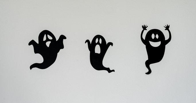 Table top view aerial image of decoration Happy Halloween day background concept.Flat lay accessories essential object to party the black ghost on rustic white stone.Space for creative design text.