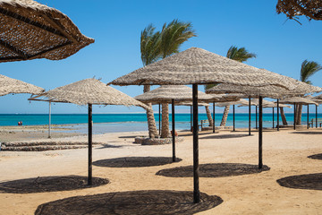 Straw sunshade umbrellas on the beach