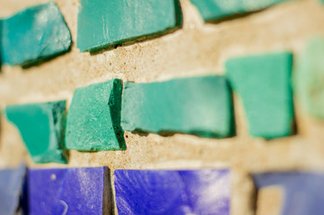 Colored stones in mosaic on the wall of a building.
