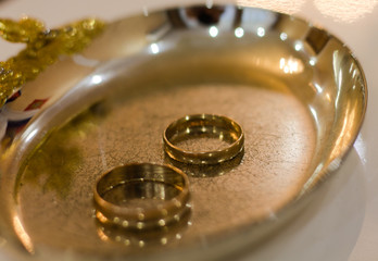 Wedding rings on a golden saucer. Wedding day. flat lay, copy space, top view