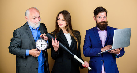 businesspeople. dream team. bearded man with laptop and alarm clock. mature men and sexy girl with bat. deadline concept. time management. dirty business and criminal. digital sport. work harder