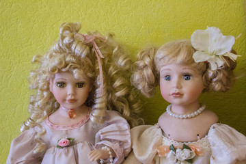Porcelain dolls on a green background.