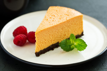 Pumpkin cheesecake with raspberries. Selective focus.