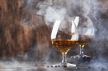 Armagnac, French grape brandy, strong alcoholic drink. Still life in vintage style with cigar...