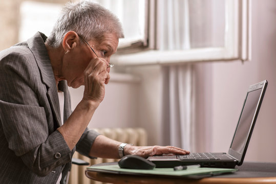 Senior Old Business Lady In Disbelief By An Email On Her Laptop