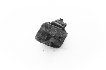 black charcoal on white background. a porous black solid, consisting of an amorphous form of...